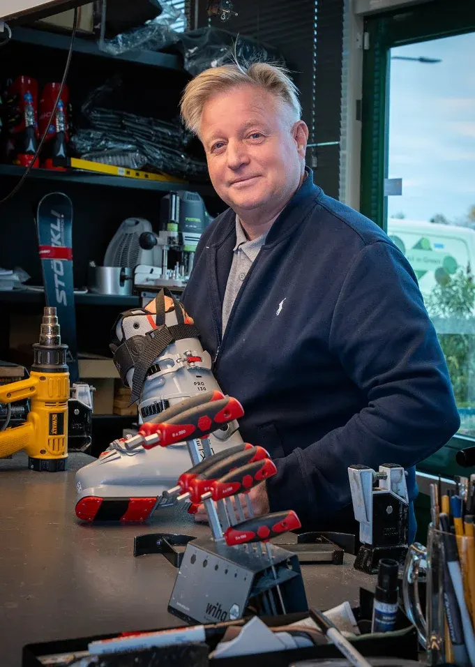 Patrick Rademaker at his workbench with a ski boot at Skicenter Edelweiss in Dieren