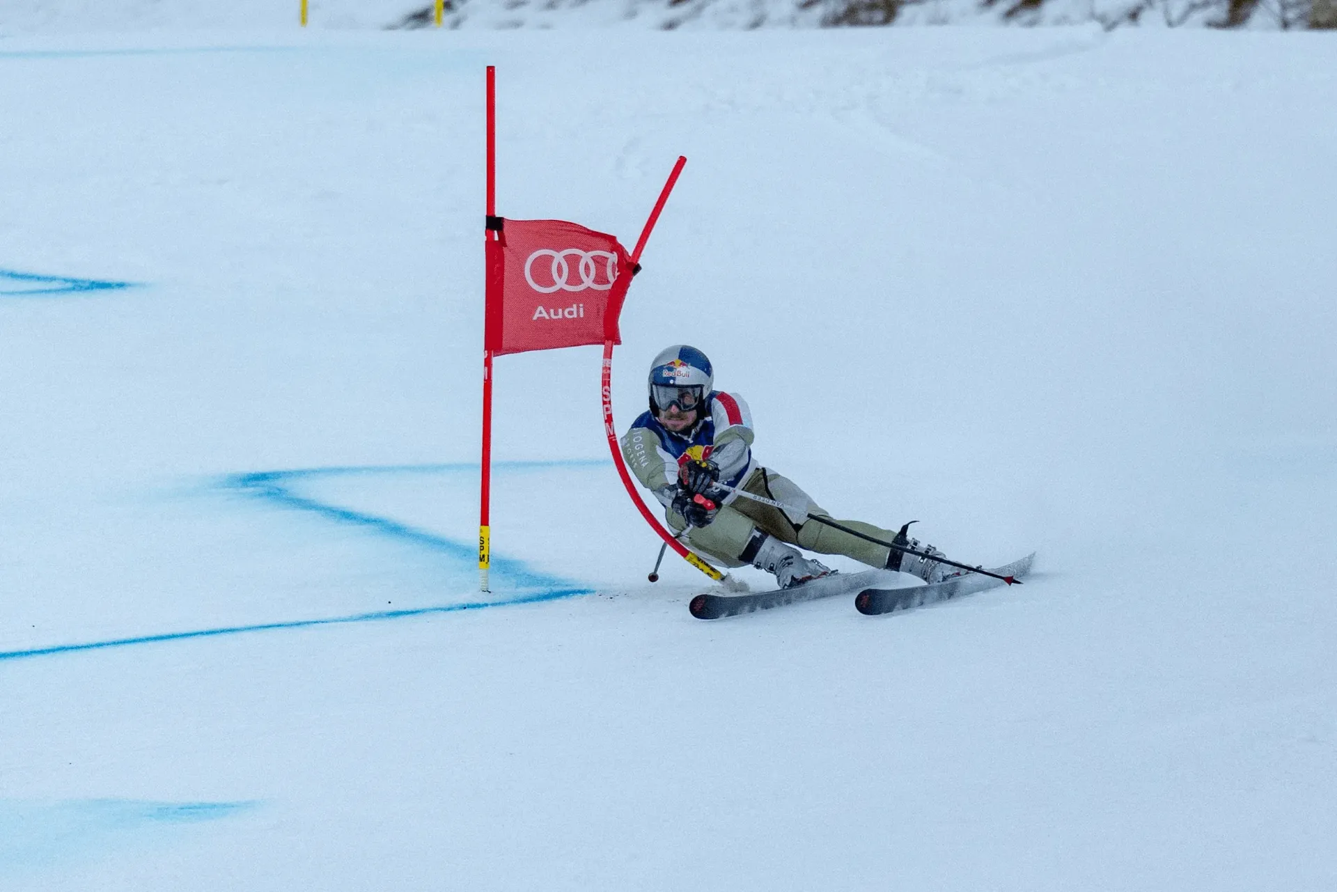 Marcel Hirscher in action past a red gate during race training